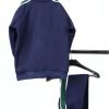 Back view Boys Navy Tracksuits with green strips hanging on hanger with white background