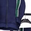 Front zoom view Boys Navy Tracksuits with green strips hanging on hanger with white background